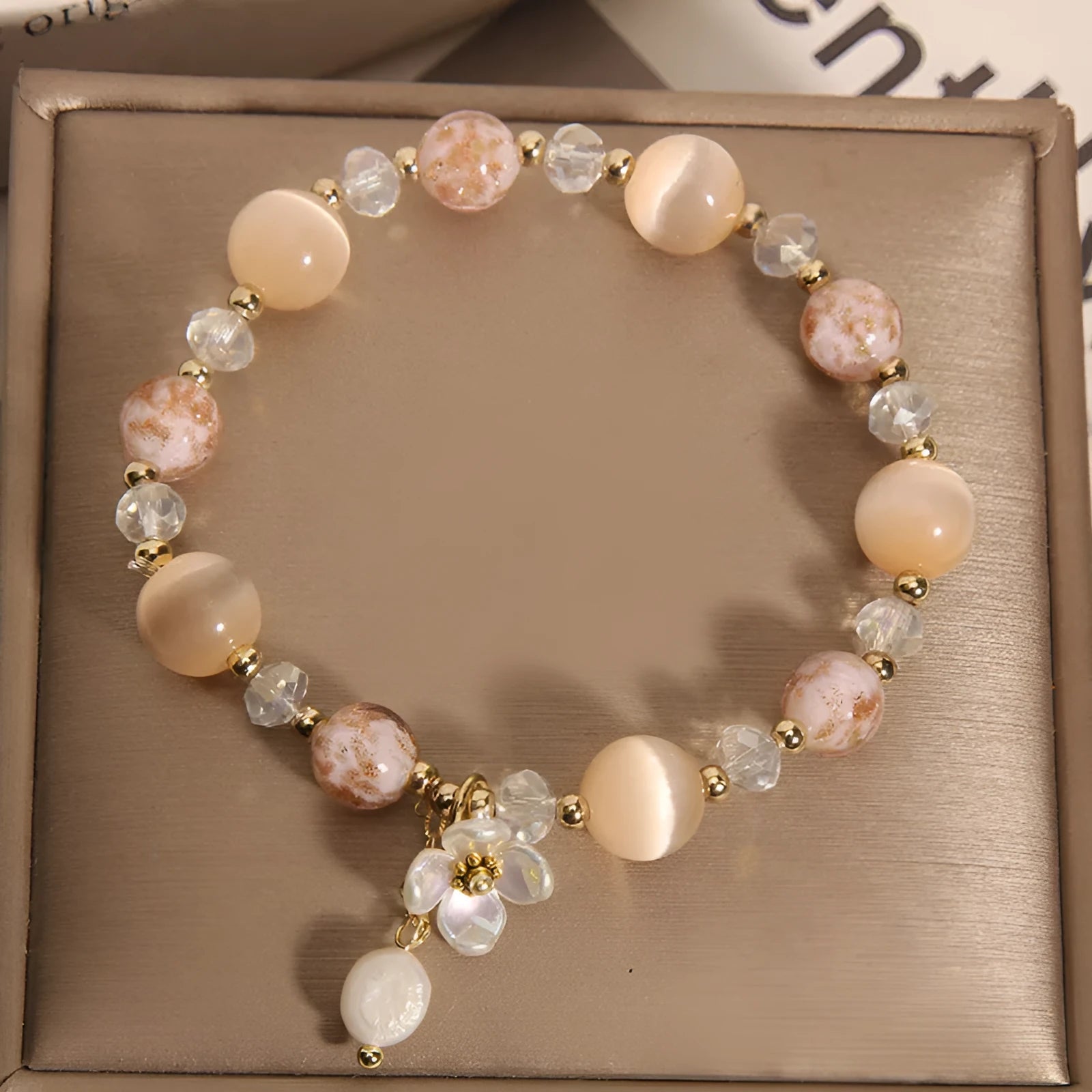 Woven aquamarine crystal bracelet with opal floral elements and cat motifs