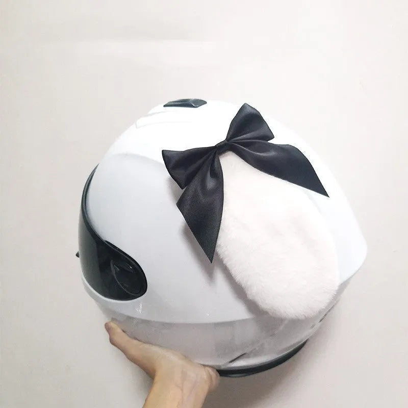 Black carbon fibre rabbit ears decoration attached to a motorcycle helmet