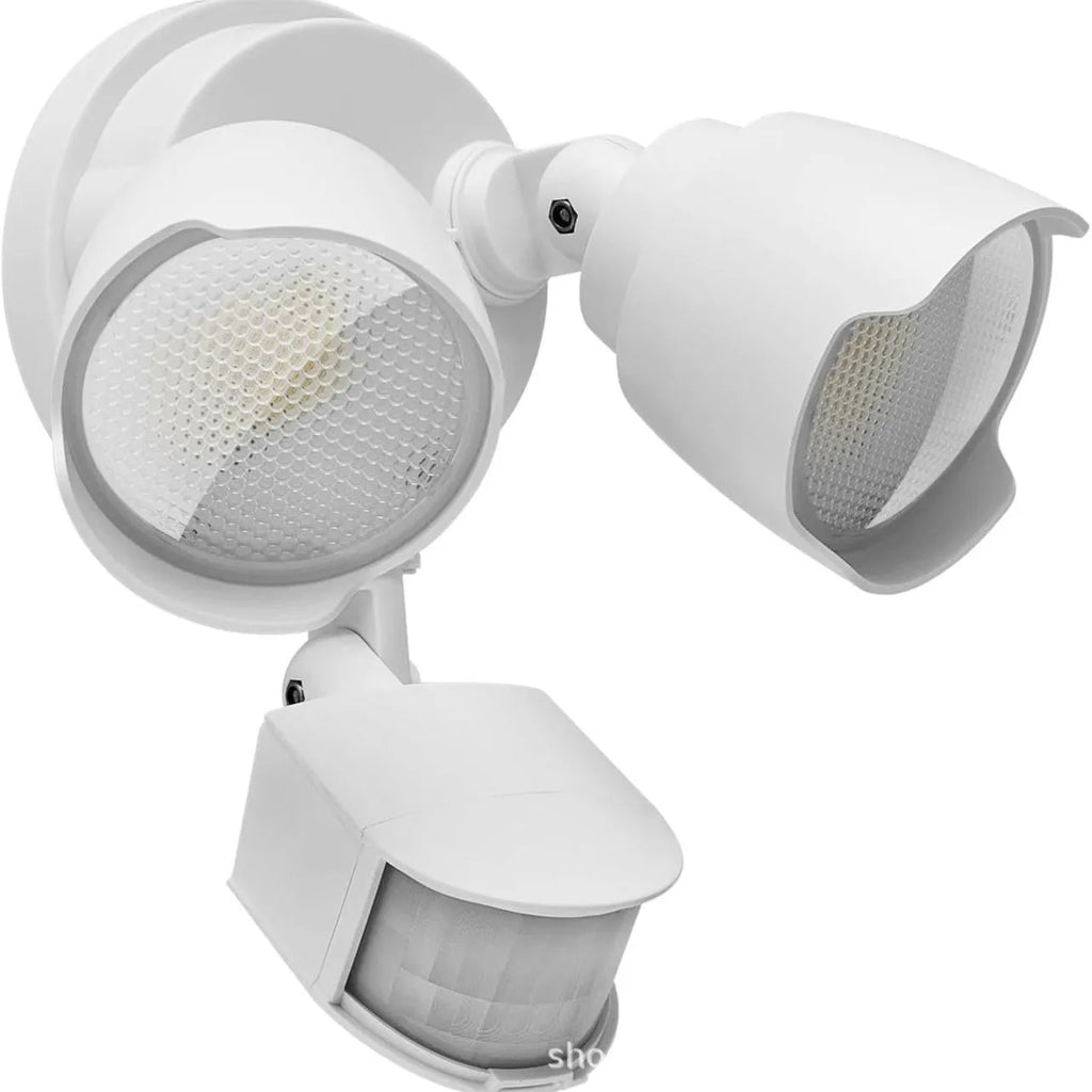 White LED security flood light with motion sensor mounted on an exterior wall