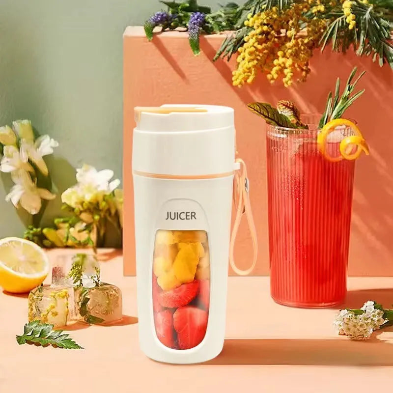 Portable USB electric blender with borosilicate glass cup in fresh orange, grass green, and light purple colours.