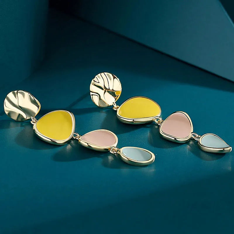 A pair of simple disc-shaped earrings with a blended Morandi colour finish on a sterling silver post.