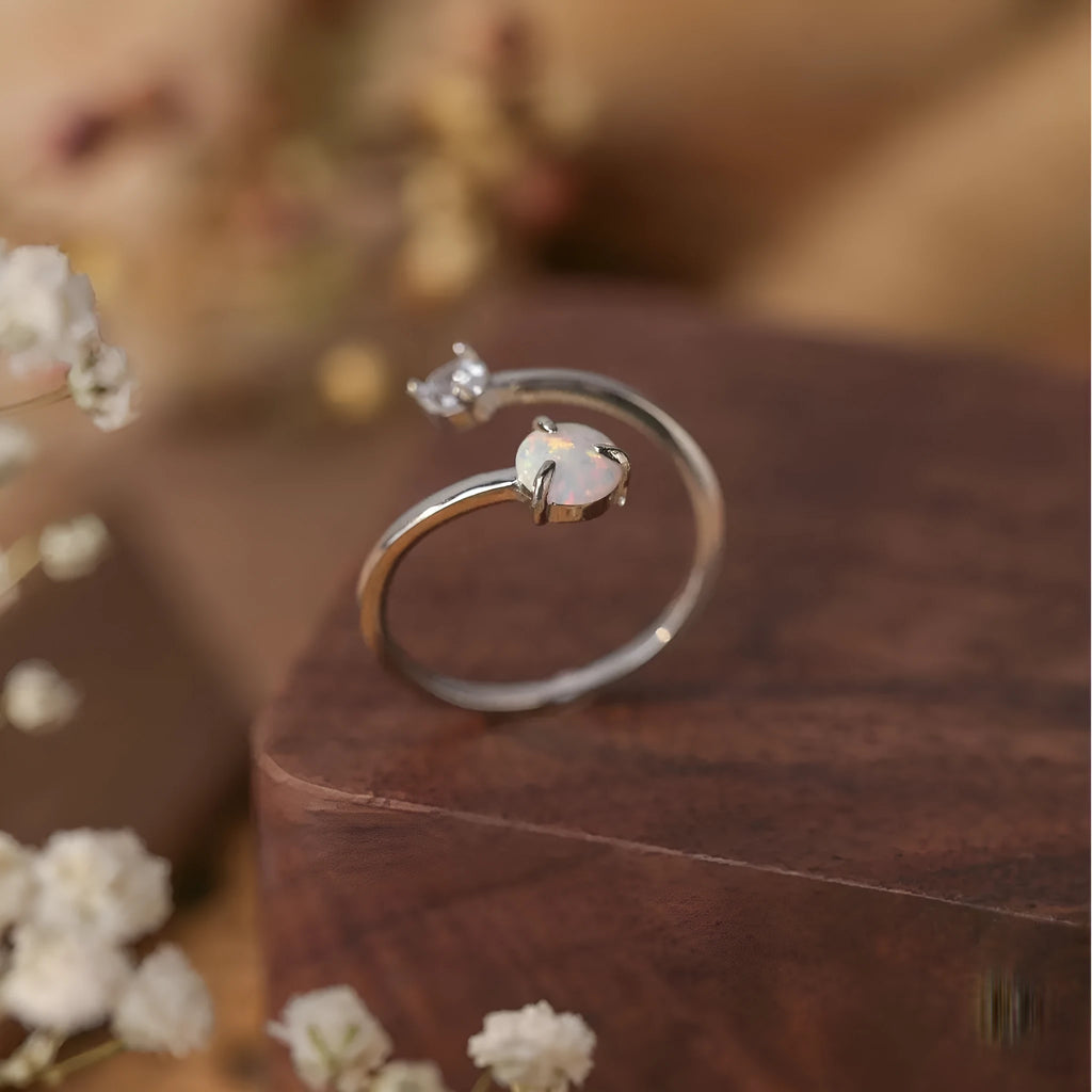 Open ring with adjustable opening, silver band, and inlaid zircon stones in gold colour