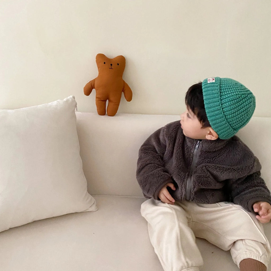 Blue children's sherpa fleece winter coat with full zip, high collar, and front pockets on a hanger.