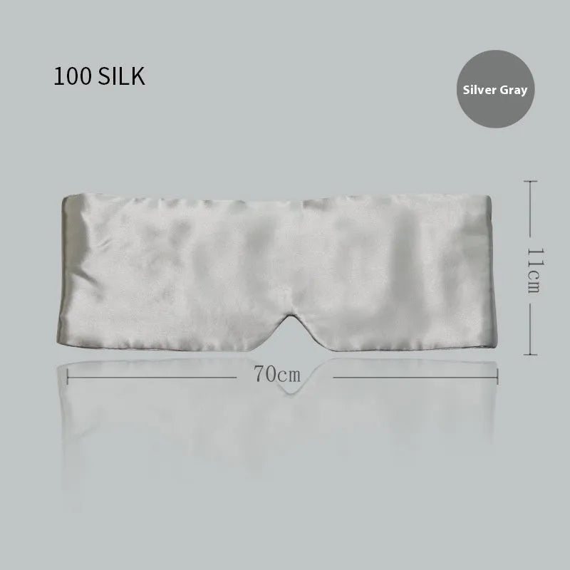 Contoured mulberry silk sleep mask in champagne gold colour, shown resting on a pillow.