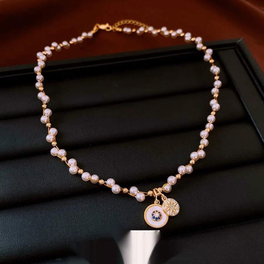 Gold-plated necklace with round pearl pendant and zircon accents on adjustable chain