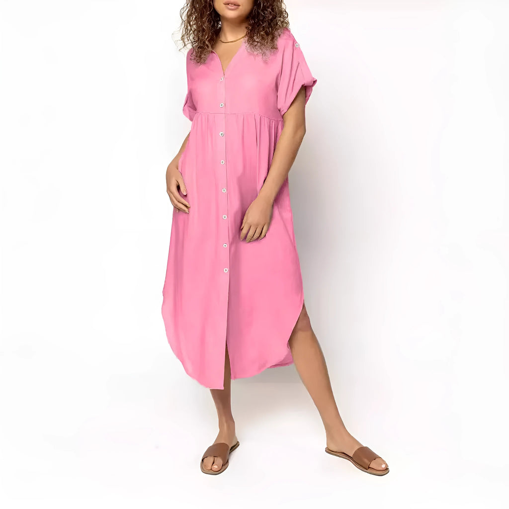 Loose-fitting mid-length casual dress with button front detail on a hanger.