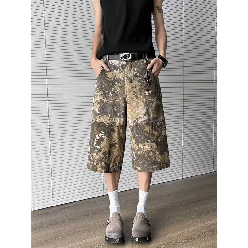 Yellow denim jeans with a snake camouflage pattern and cropped leg hem.