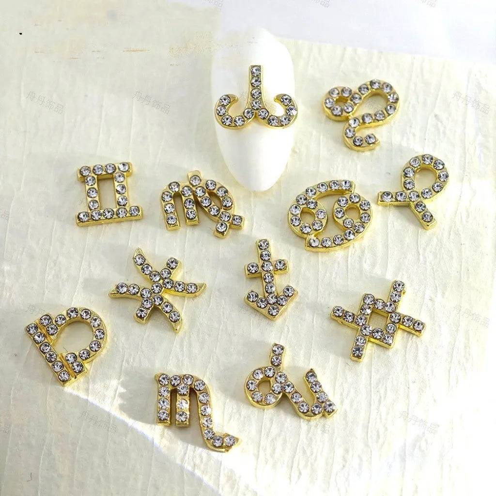 Twelve zodiac nail art accessories in alloy with diamond inlays, silver and gold finish, starry sky pattern.