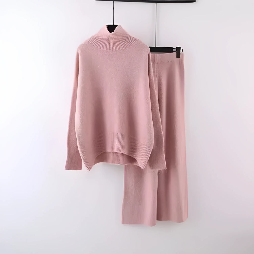 Women's milky white acrylic knit two-piece set featuring a long-sleeve sweater and wide-leg trousers on a hanger.