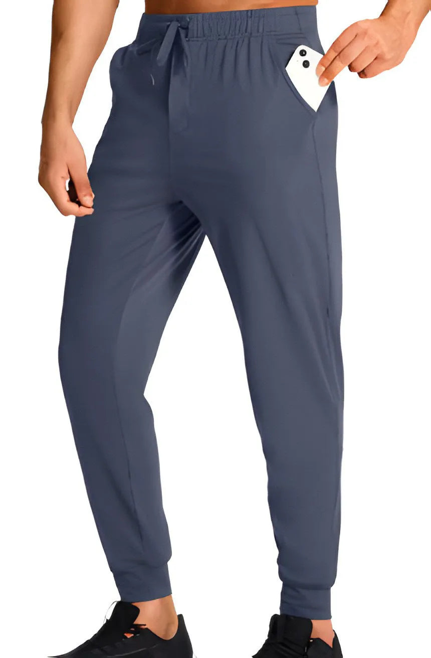 Man wearing loose-fit solid colour casual trousers made from polyester fabric.