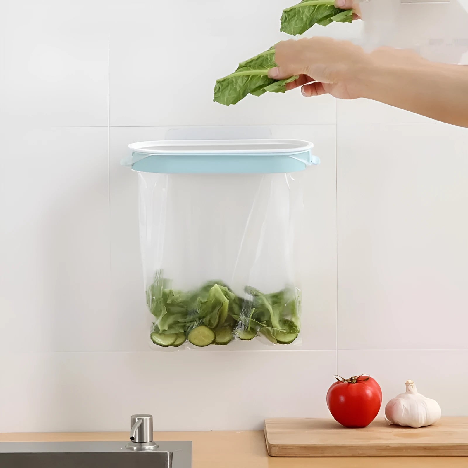 Blue plastic T-shaped kitchen garbage bag storage rack holding a roll of bin liners.