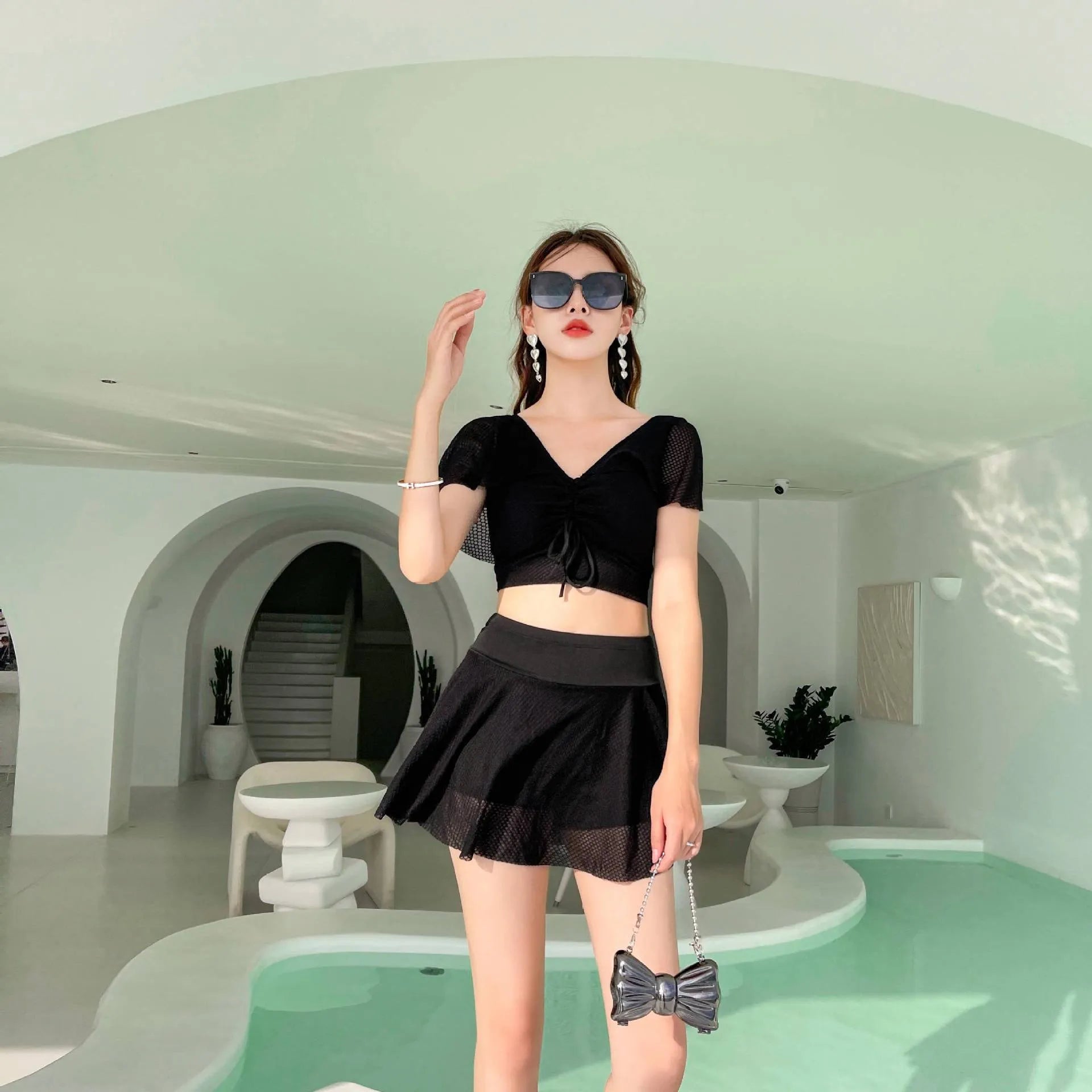 Women's solid colour two-piece swimsuit with a separate top and skirt.