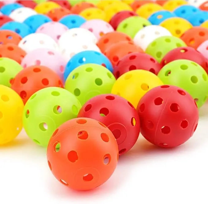 Assortment of red, orange, blue, green, white, and yellow 42mm golf practice balls in a net.