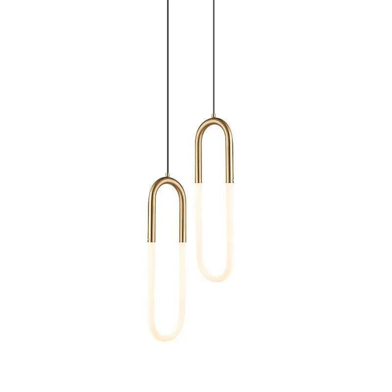 Modern Nordic style U-shaped white pendant light hanging above a wooden bedside table.