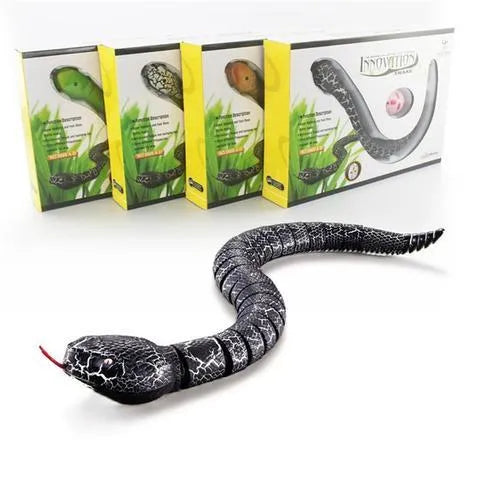 Novelty Remote Control Snake in green colour, 38 cm plastic toy with retractable tongue on a wooden floor