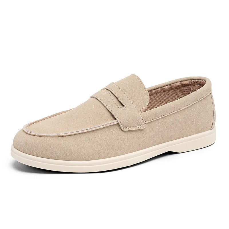 Men's beige suede British style casual slip-on shoes with a round toe and low flat heel on a rubber sole.