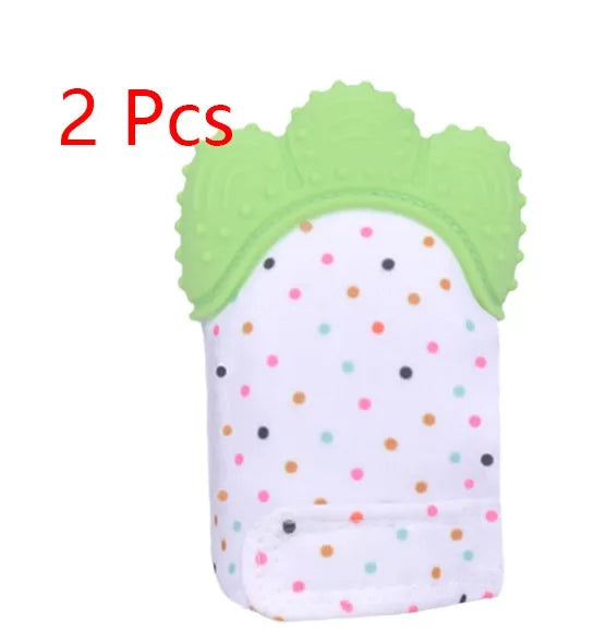 BPA-free silicone baby teether glove fastened with a white Velcro strap on a baby's hand