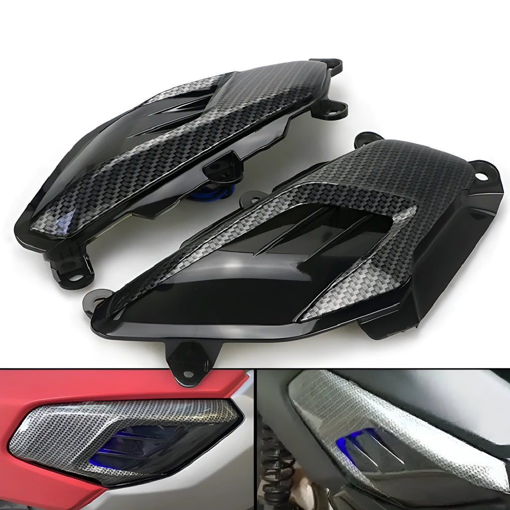 Pair of YAMAHA NMAX carbon fibre-look LED side lamp replacements on a blue background.