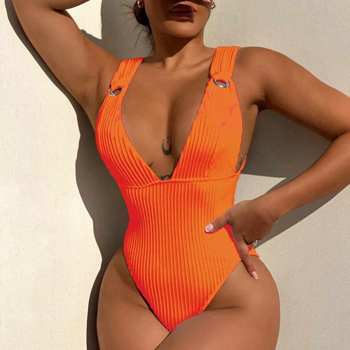 Women's solid colour one-piece swimsuit in spandex, shown in black, white, green, and orange.