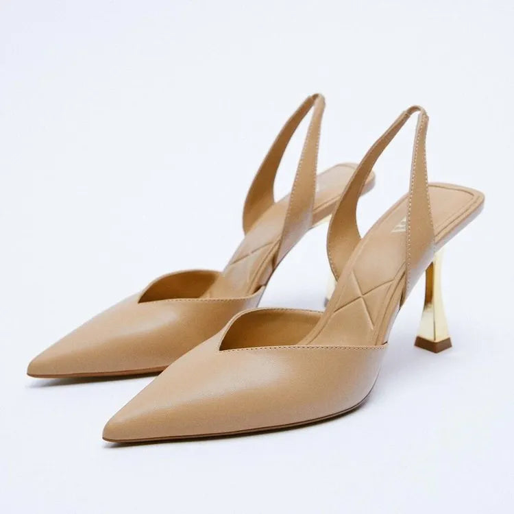 Women's pointed-toe patent leather high heels in nude colour with a shallow-cut vamp.