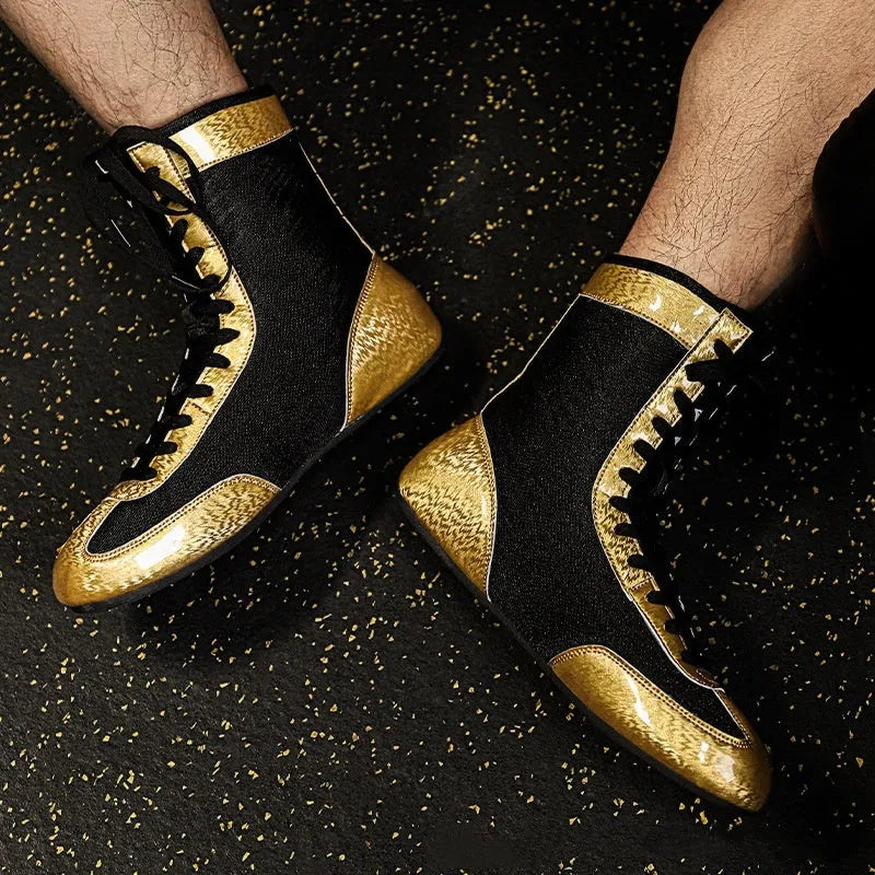 Professional boxing shoes with leather and mesh construction in black gold colour with non-slip soles