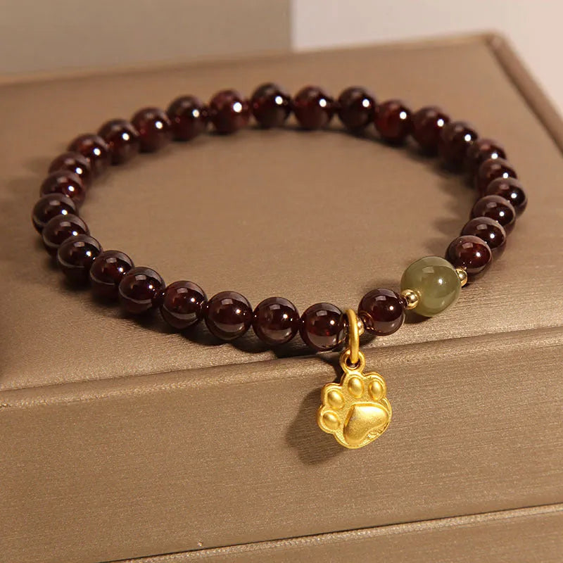 Women's Cat's Paw Garnet crystal bracelet on wrist, original design.