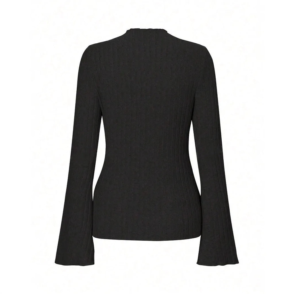 A person wearing a black long sleeve round neck top with a brushed sunken stripe texture and lantern sleeves.