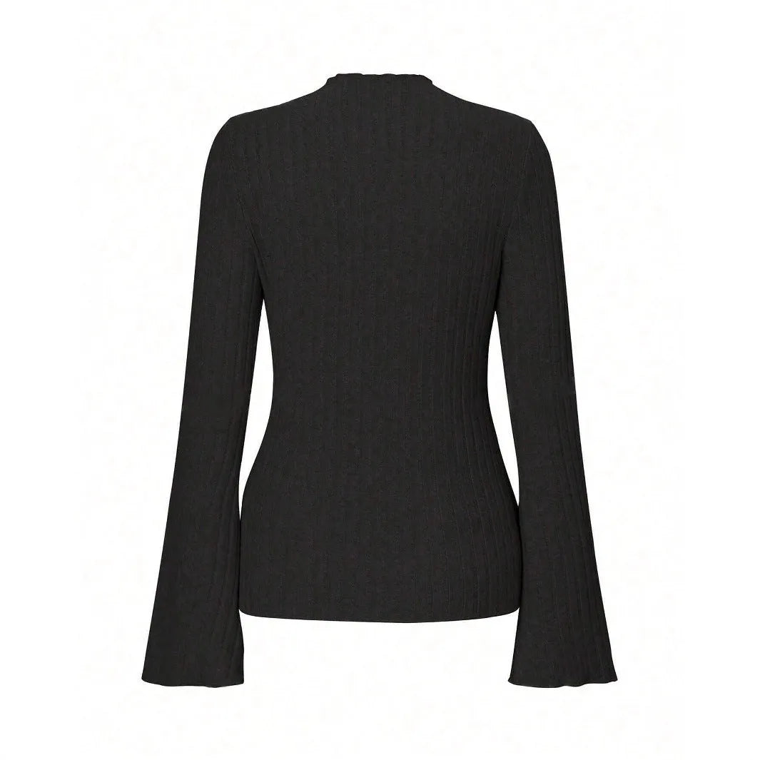A person wearing a black long sleeve round neck top with a brushed sunken stripe texture and lantern sleeves.