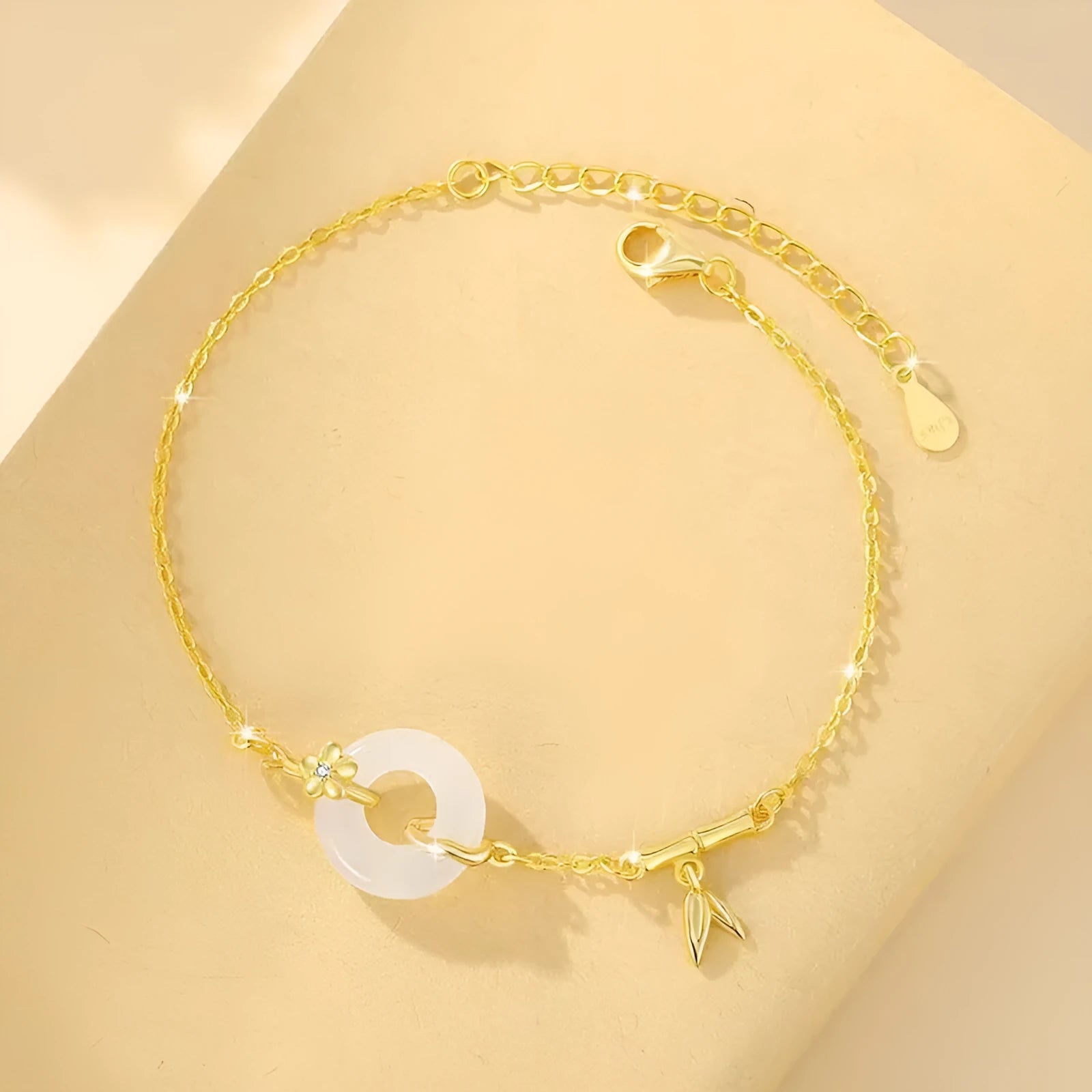 Silver women's bracelet with peace buckle charm, white chalcedony stone, and starry sky design with gold electroplating.