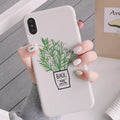 White silicone iPhone case with a detailed painted plant pattern on the back, showing its 360-degree protective edges.