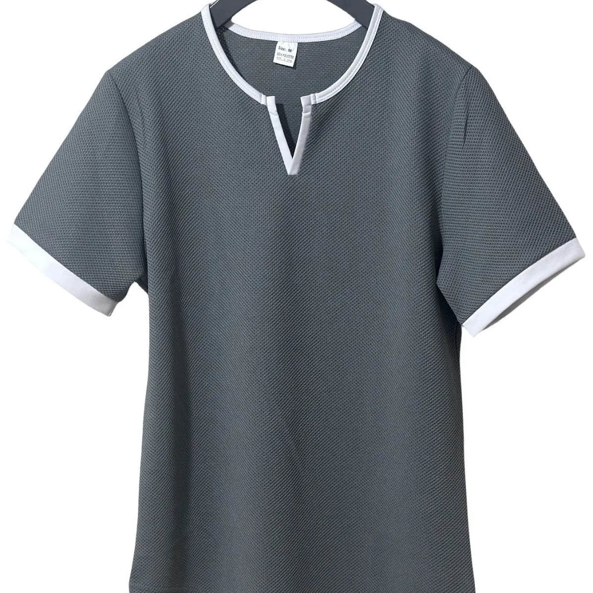 Colour-block V-neck short sleeve t-shirt in polyester waffle fabric on a neutral background.