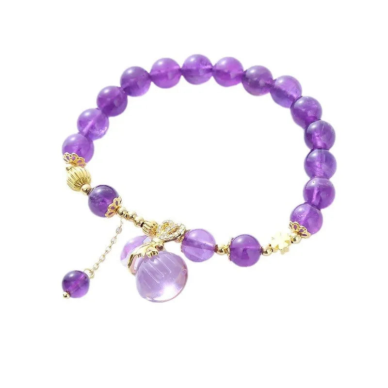 Purple amethyst crystal bracelet with money bag pendant and geometric peace buckle on wrist