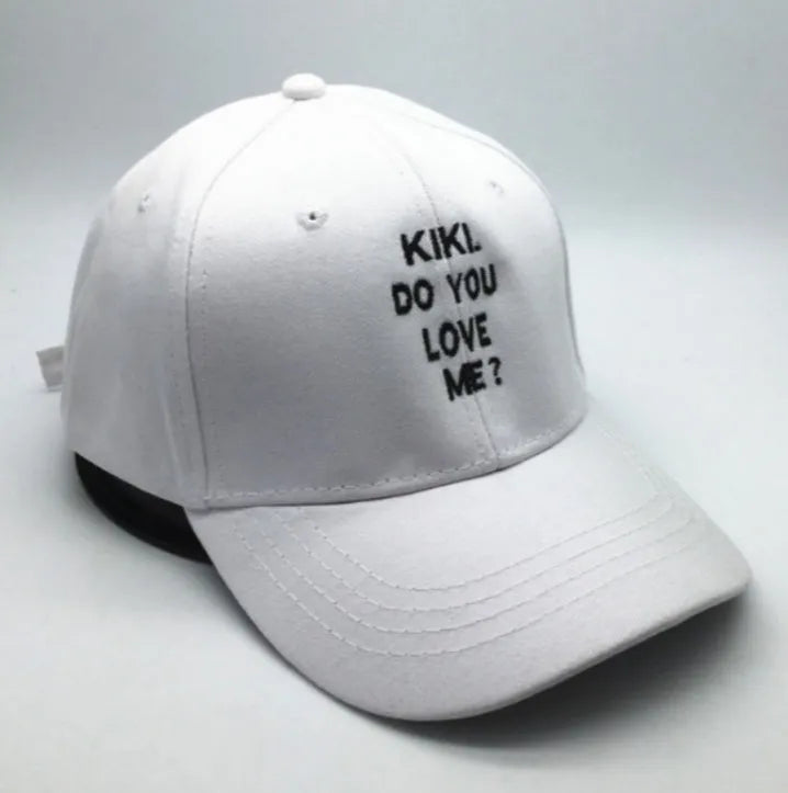 Letter embroidered cotton baseball cap in black with curved brim on white background