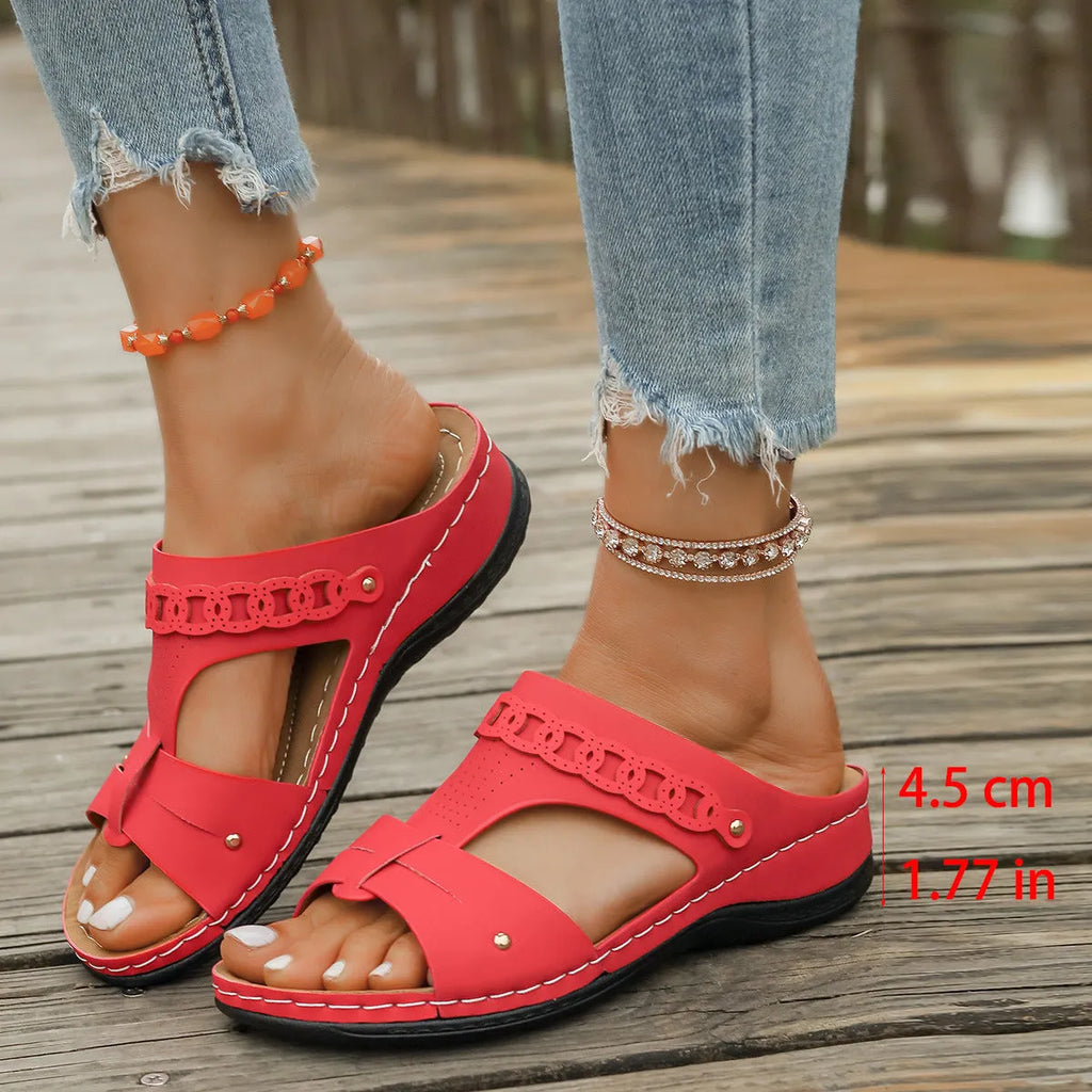 Pair of casual Roman style slippers with a fish mouth toe holder and slope heel, shown in a choice of colours.