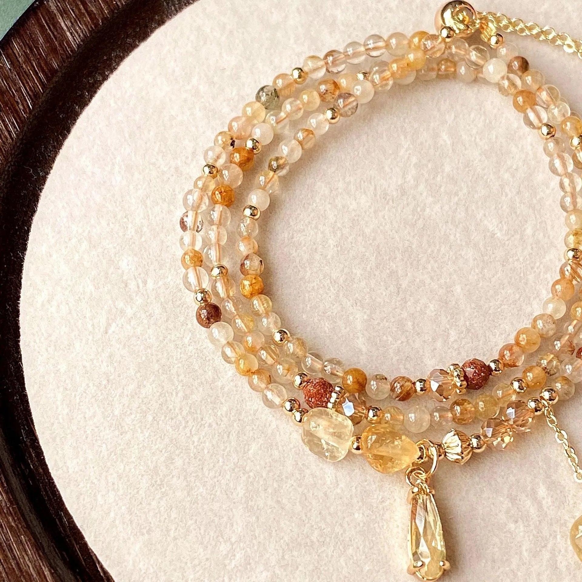 Gold multi-layer bracelet with citrine crystals and three-circle Saturn design