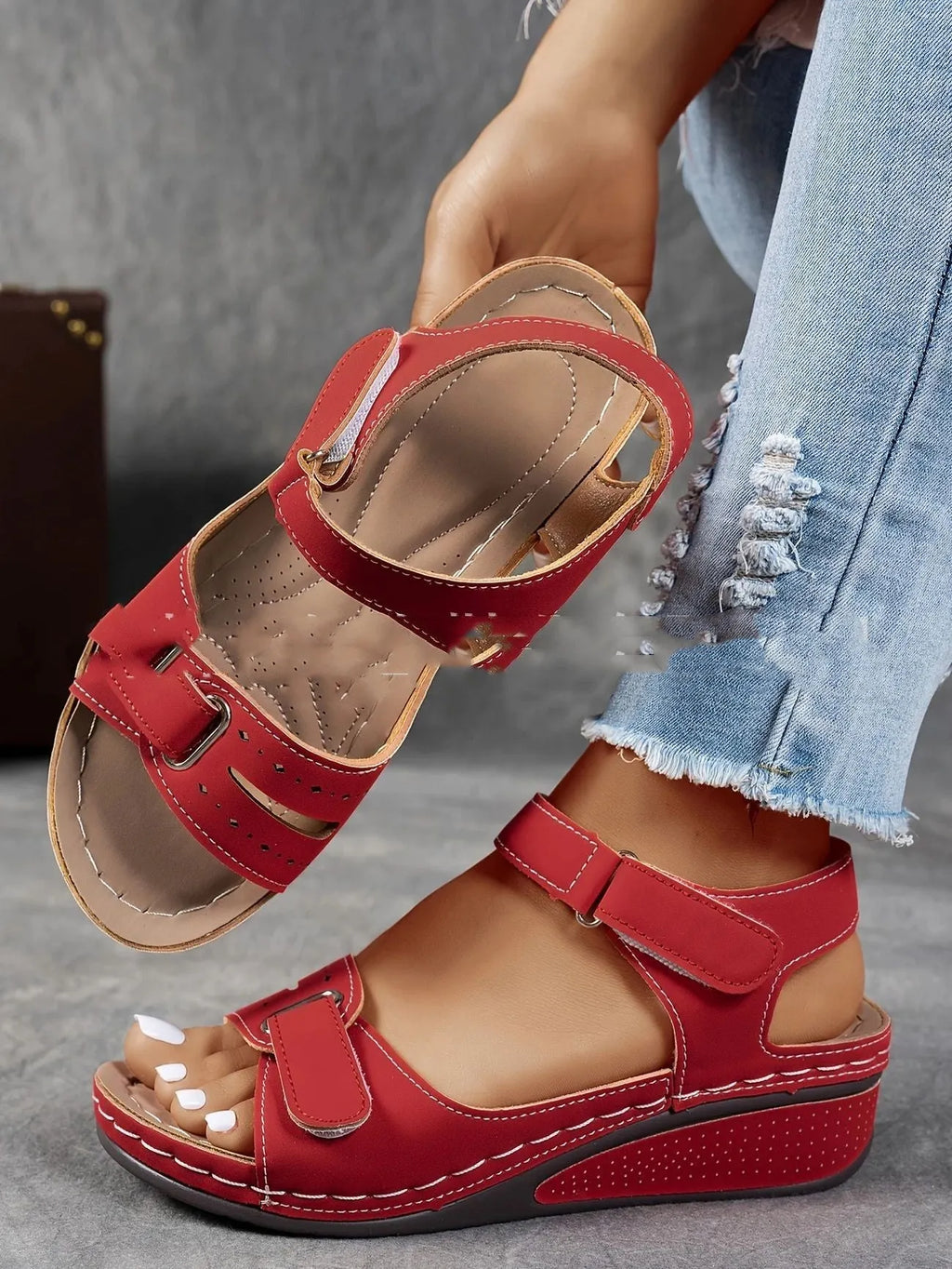 Women's beige thick-bottom strap sandals showing the Velcro fastener and round toe design.