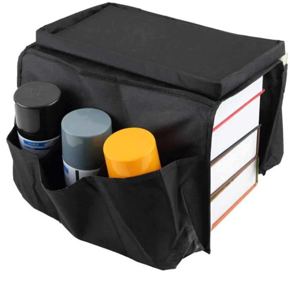 Black Oxford fabric sofa armrest organiser bag with 6 pockets on a couch handrail
