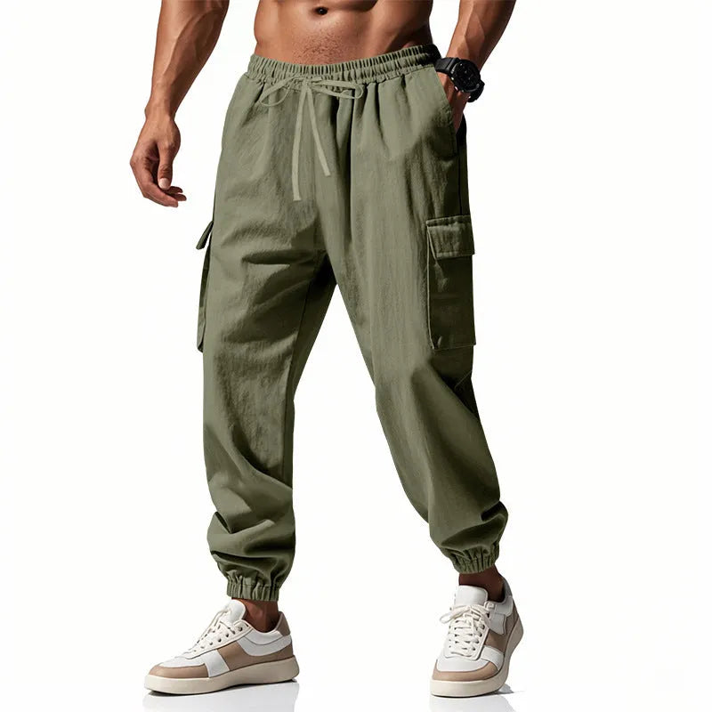 Man wearing loose-fit khaki linen casual trousers with ankle ties and multiple pockets.