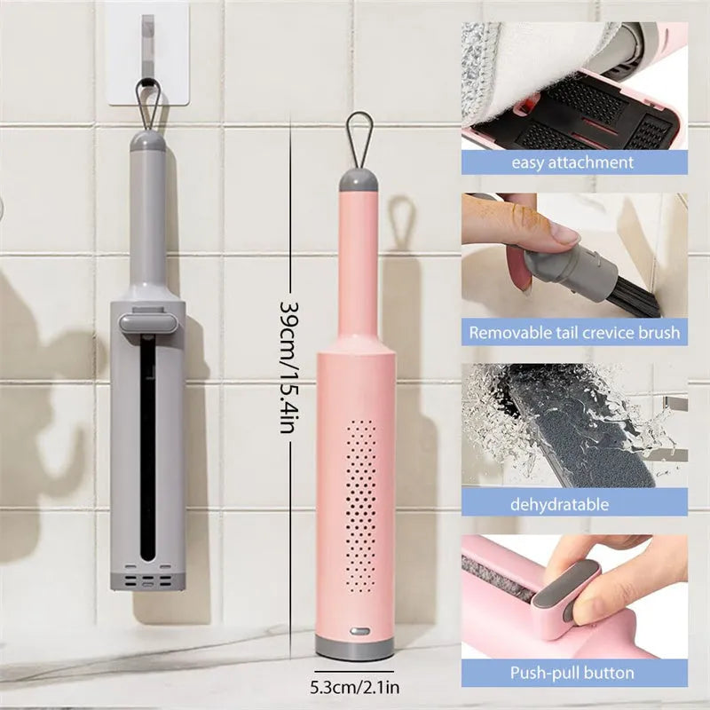 Pink self-squeezing rotatable mini flat mop with microfiber pad on a hardwood floor.