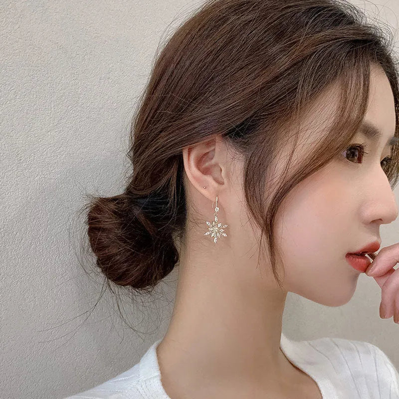 Gold alloy snowflake earrings with central zircon stone for women