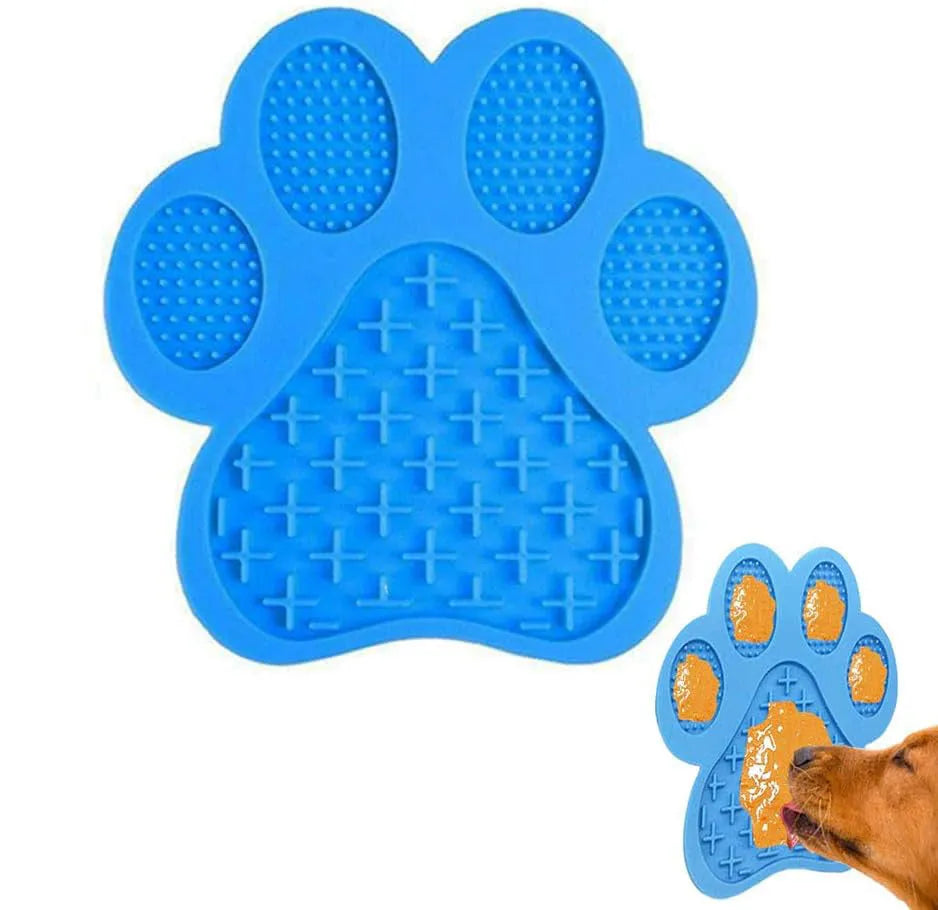 Blue bone-shaped silicone dog licking mat with suction cups on a tiled shower wall.