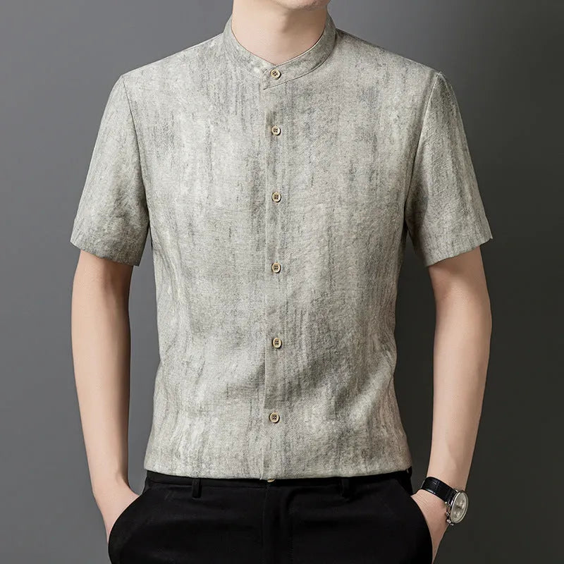 Man wearing a grey loose-fit linen blend cardigan shirt with a stand collar.