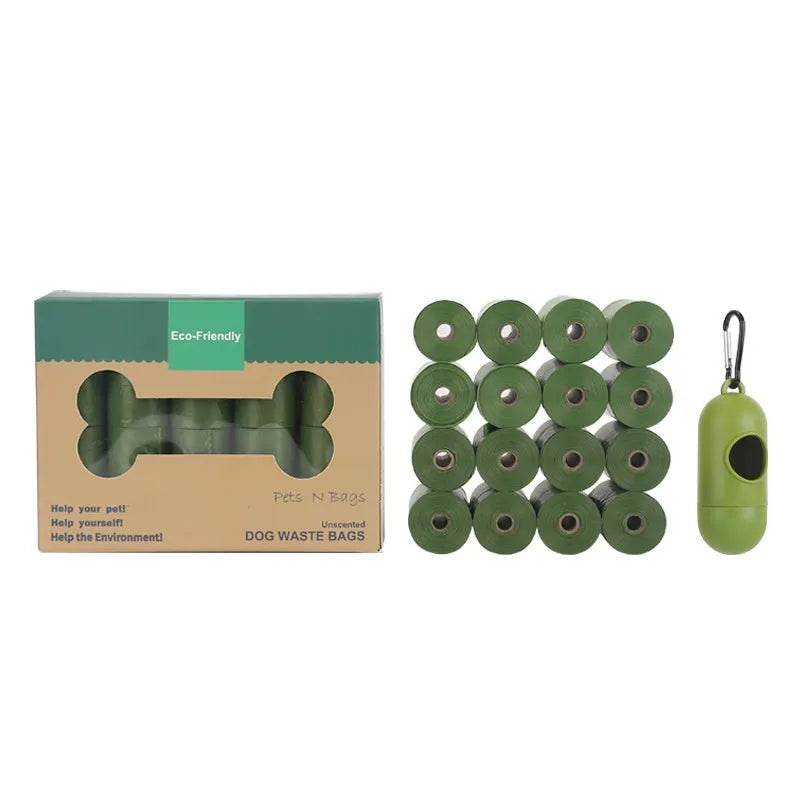 Roll of green EPI degradable pet poop bags next to a transparent dispenser on a dog lead.