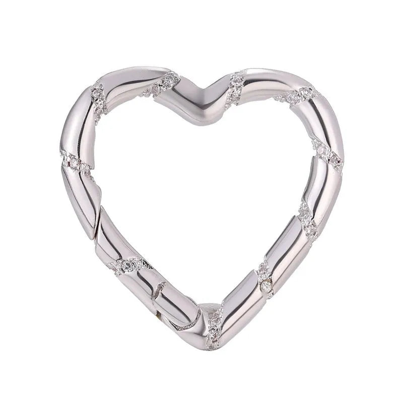 Copper climbing heart button fastener with micro-inlaid zircon stones and gold electroplating.