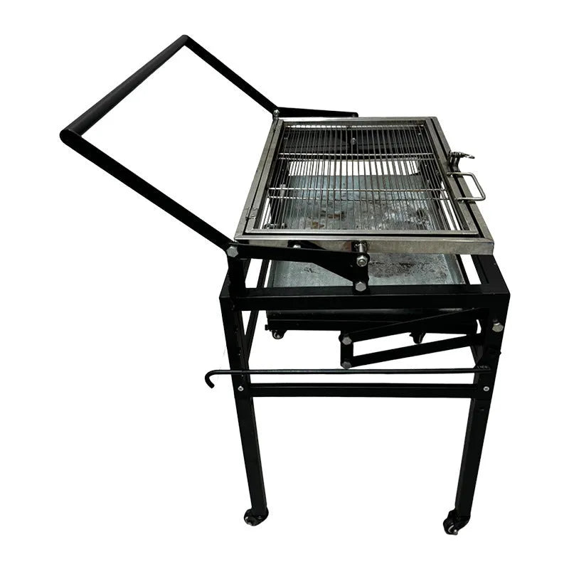 Foldable charcoal BBQ stove with a detachable grill, set up in an outdoor garden.