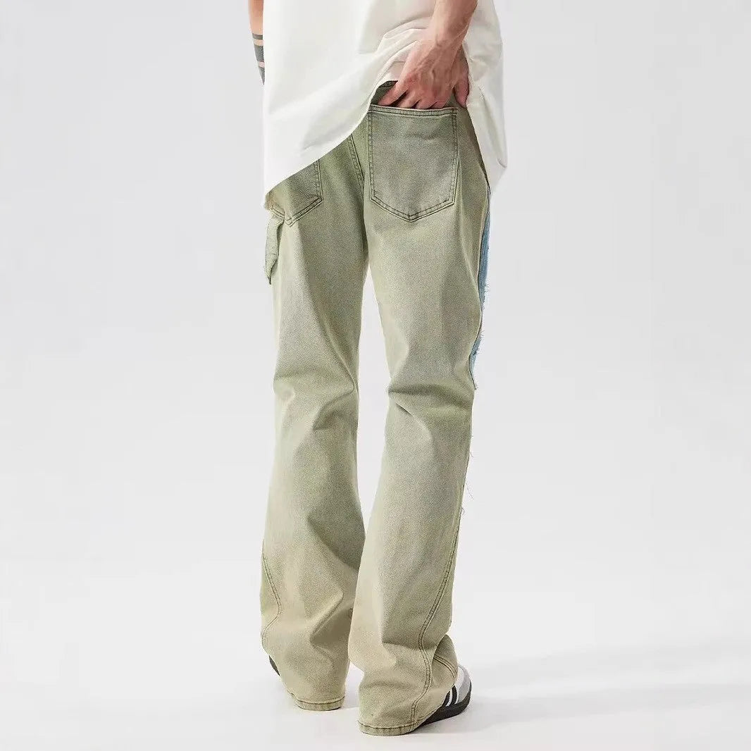 Yellow and blue patchwork distressed denim jeans with a mid-rise waist and zip fly.