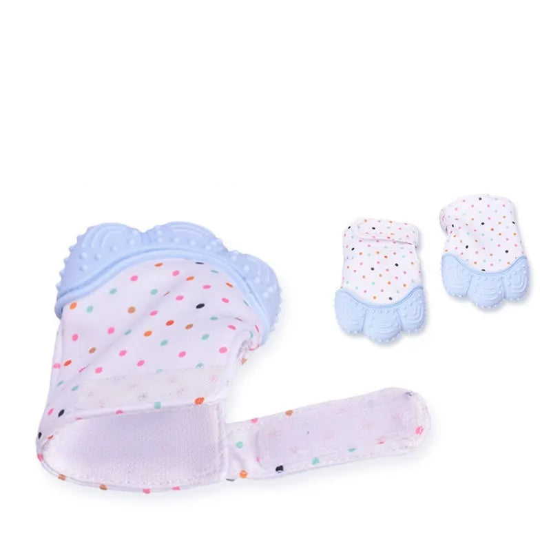 BPA-free silicone baby teether glove fastened with a white Velcro strap on a baby's hand