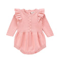 Baby girl wearing a soft pink cotton princess-style romper with a hedging placket.