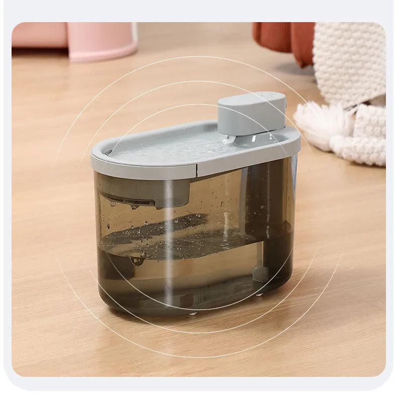 Automatic plastic drinking bowl for cats with infrared sensor, grey colour, on floor