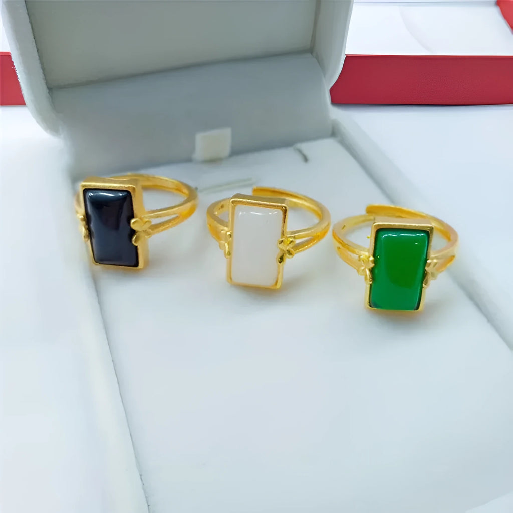 Adjustable brass gold-plated ring with a green gemstone inlay, showing national style design